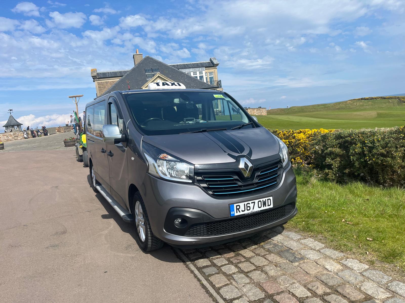 Grey Renault Trafic taxi minibus at a St Andrews golf course